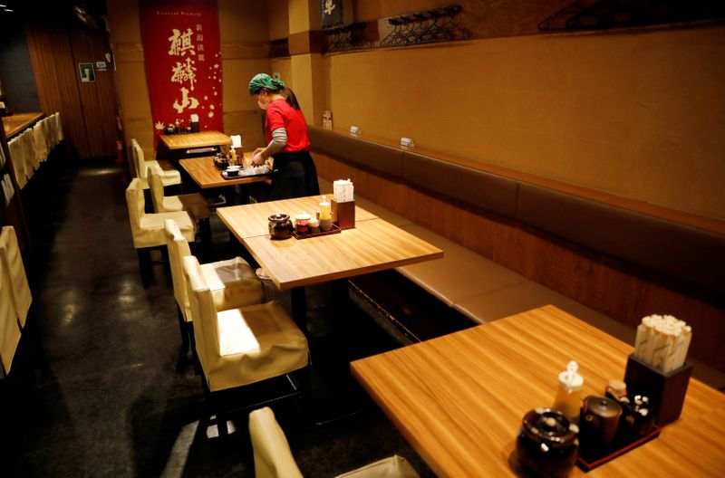 Japan's household spending slumps by record as curbs hit travel, dining out