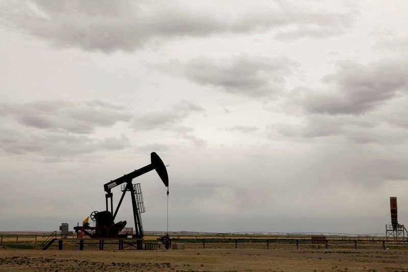 Oil ticks up, but gains capped by demand destruction